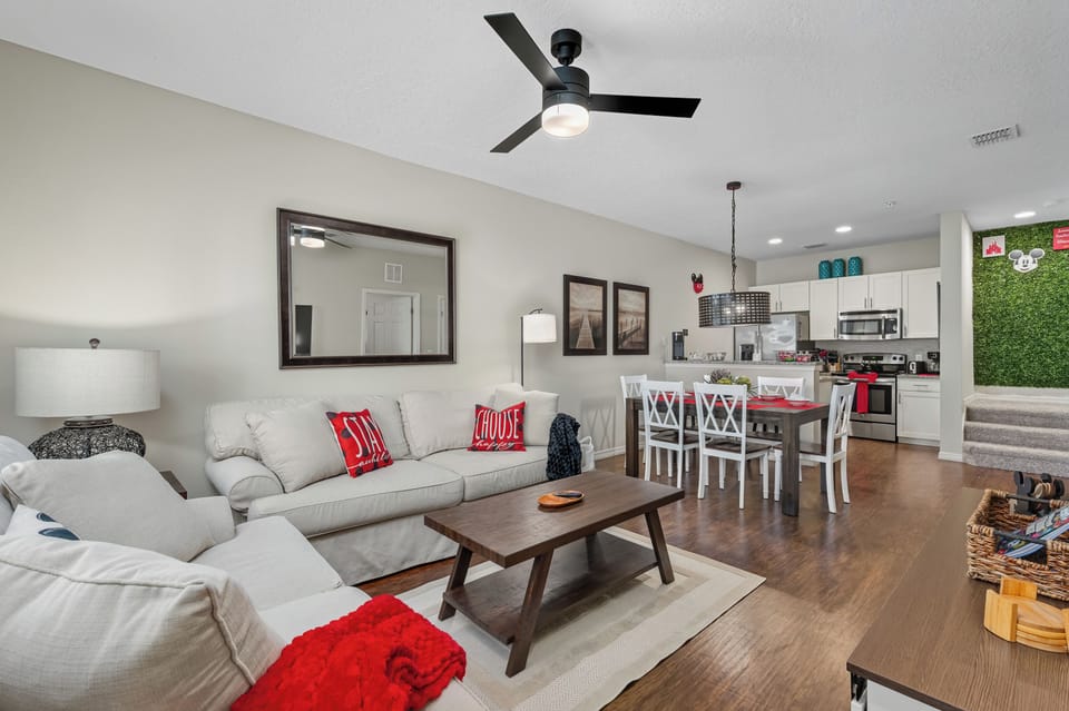 Bright open-concept space-new paint, modern ceiling fan, and stylish dining area