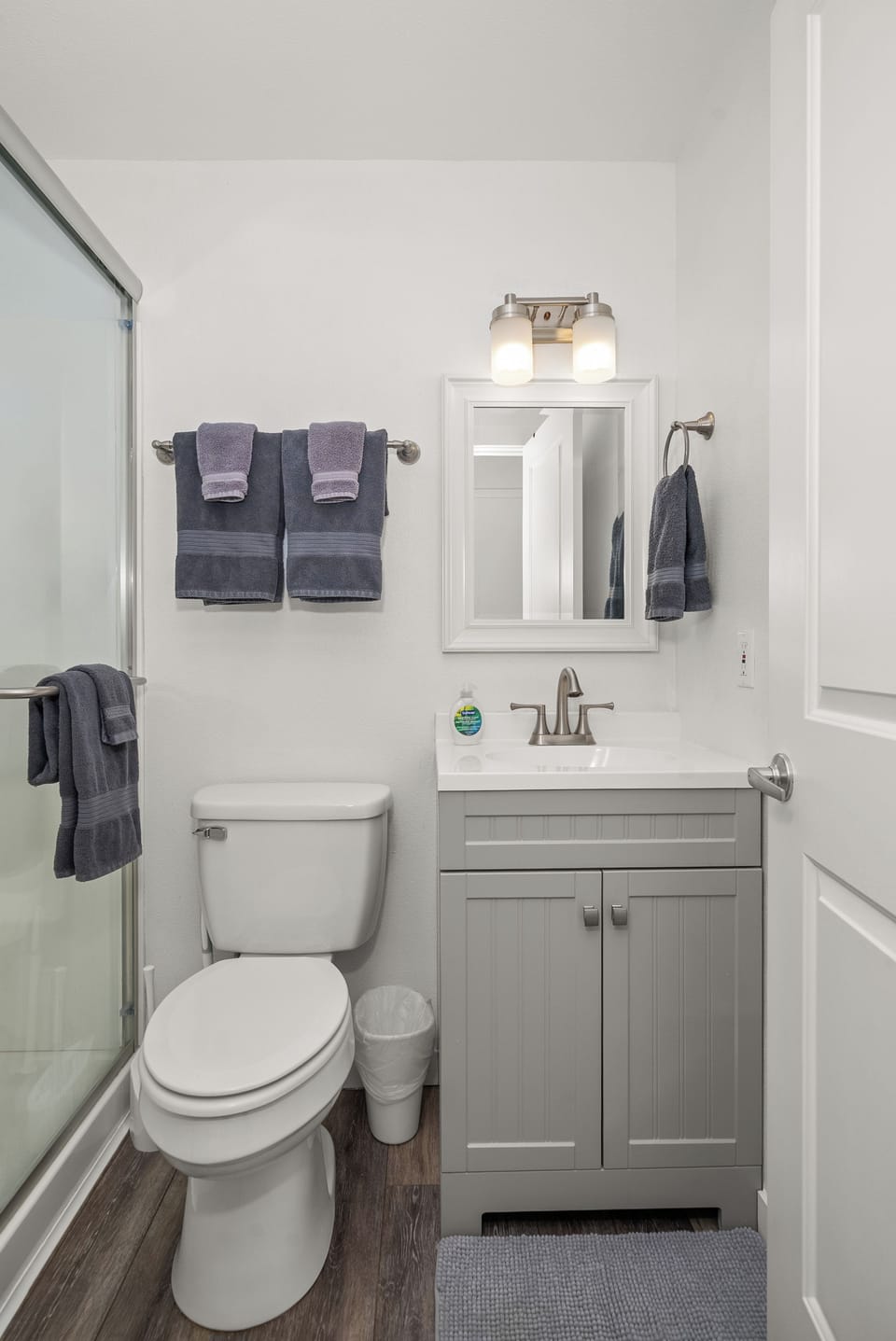 Bright modern bathroom with glass shower and stylish updated finishes