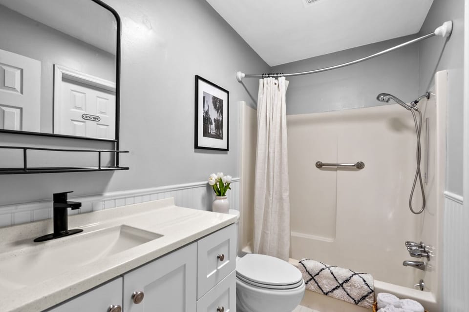Bathroom with a vanity, shower and towel rack at The Gritz Carlton in Cherry Grove, North Myrtle Beach