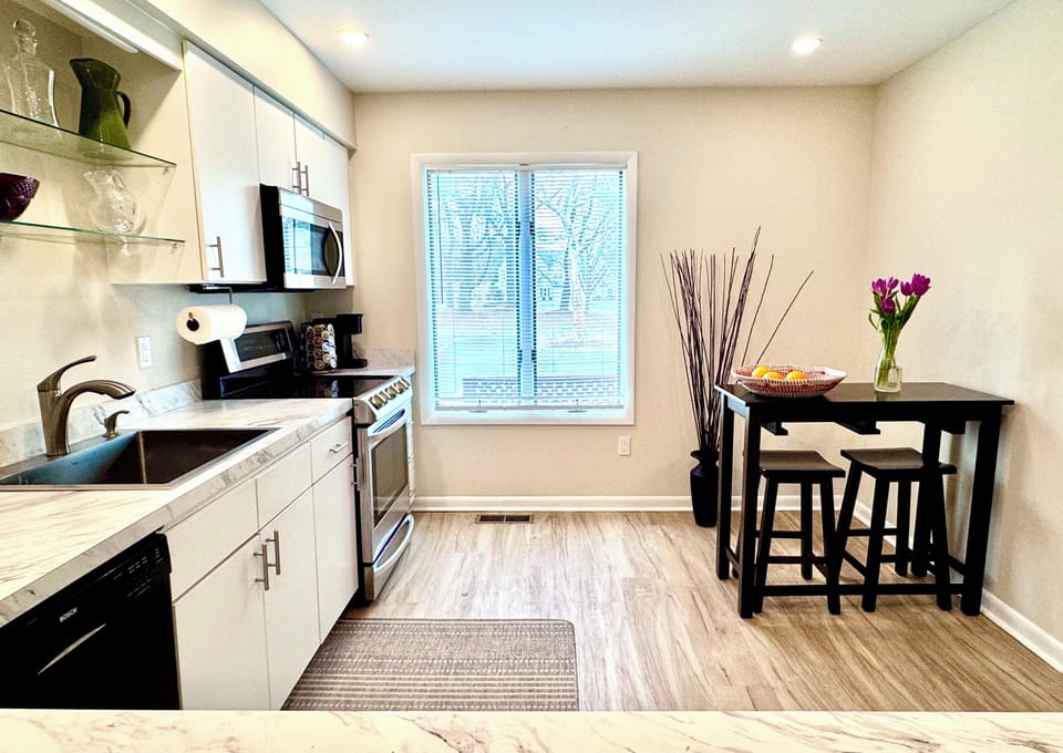 Fully equipped kitchen — Sonos wireless speaker, stainless steel appliances, ample counter space, and breakfast bar.