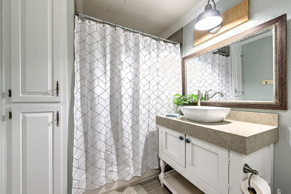 Head down the hall to our guest bathroom complete with Shower/Tub Combo.