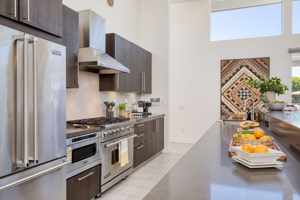 Modern stainless appliances, including a gas range.