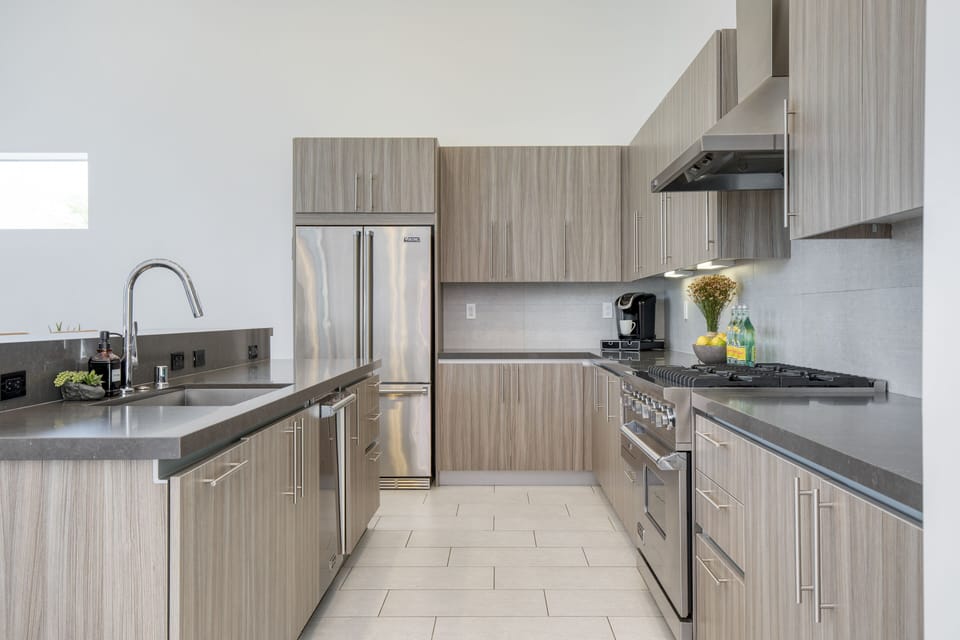 Fully-equipped chef's kitchen includes modern appliances and a gas range.