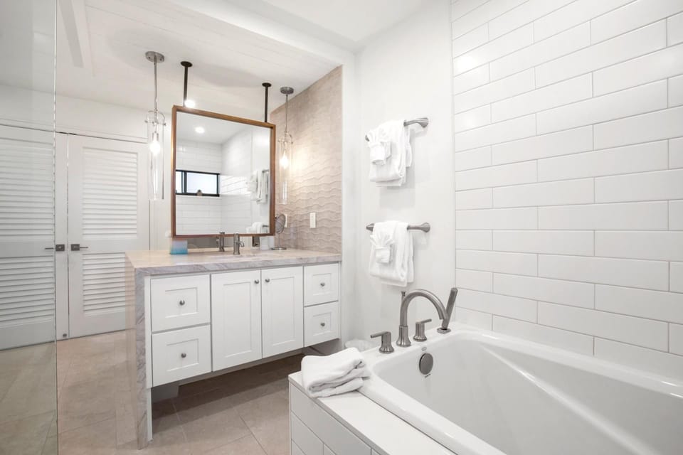 Built-in niches offer convenient space for soaps and toiletries without interrupting the clean lines of the design