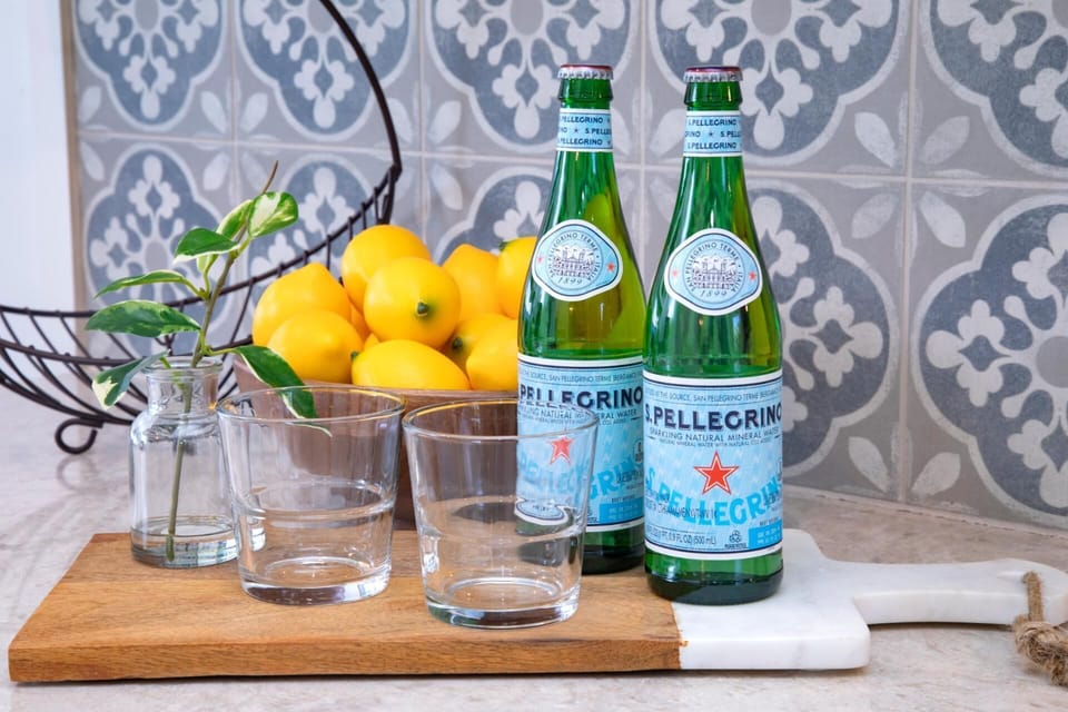 Start your mornings with sparkling San Pellegrino and fresh lemons, thoughtfully arranged for your refreshment   
