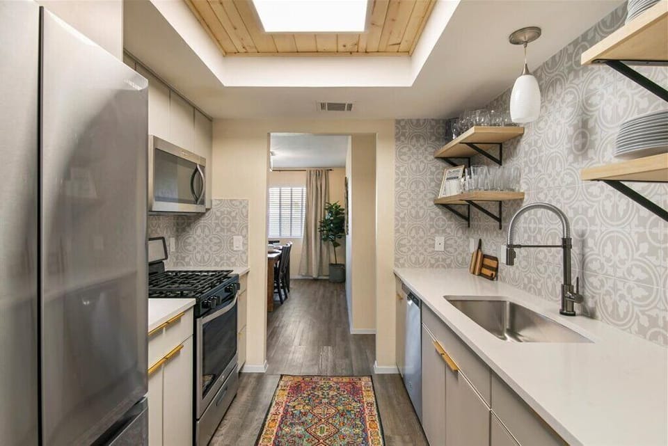 Fully stocked kitchen: full-size appliances, pots and pans and small appliances.