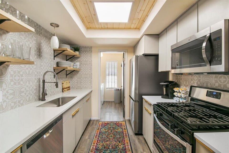 Fully stocked kitchen: full-size gas range, microwave and full-size dishwasher.