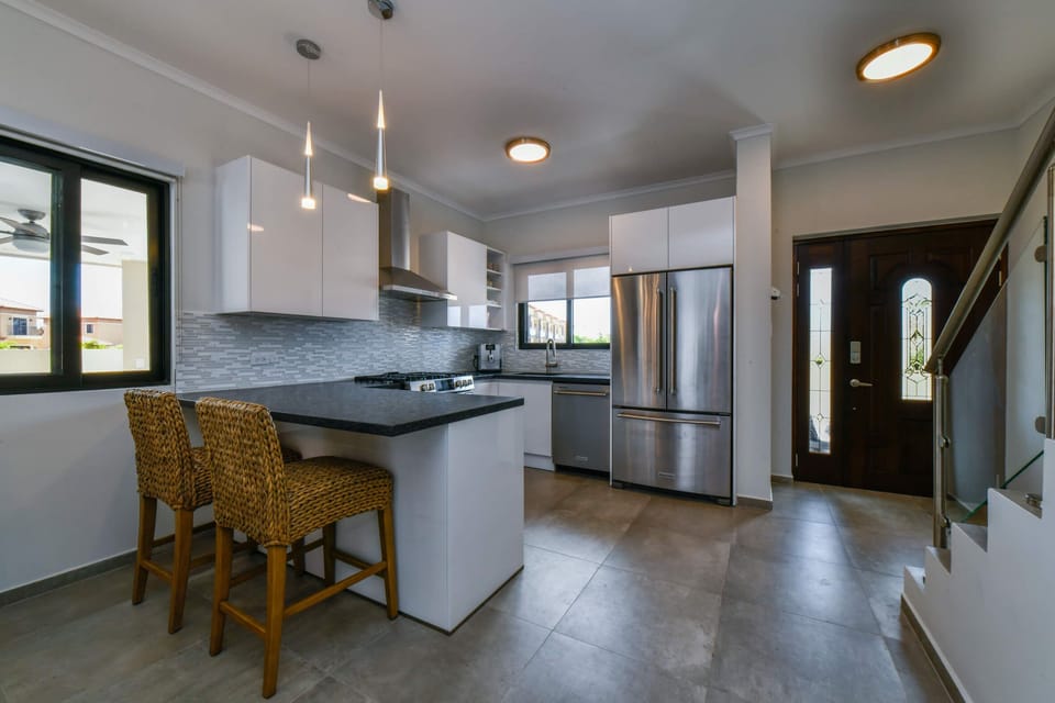 Front entrance with open-concept, modern kitchen