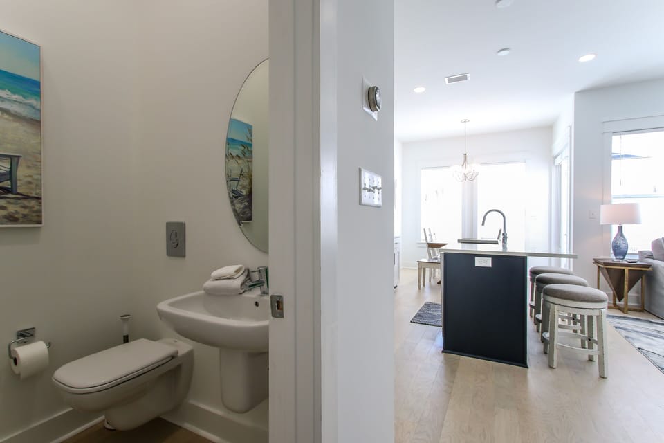 Half bathroom on 1st floor upon entering garage