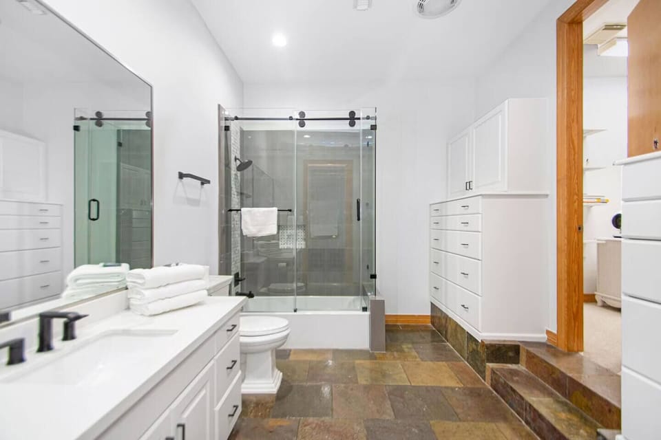Upstairs private bathroom 2 with a bathtub, shower, and a toilet.