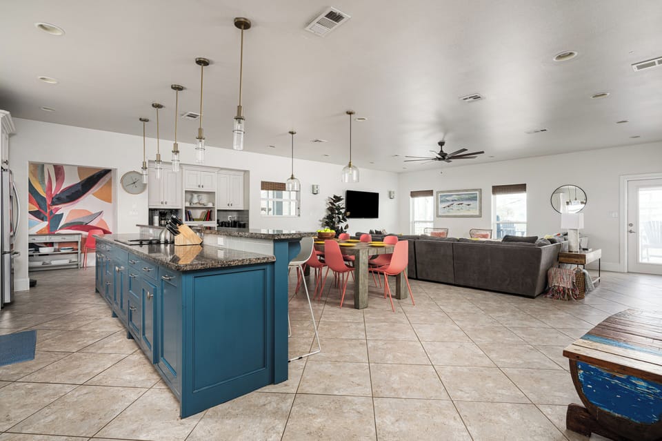 Socialize with others in the living room while cooking and eating