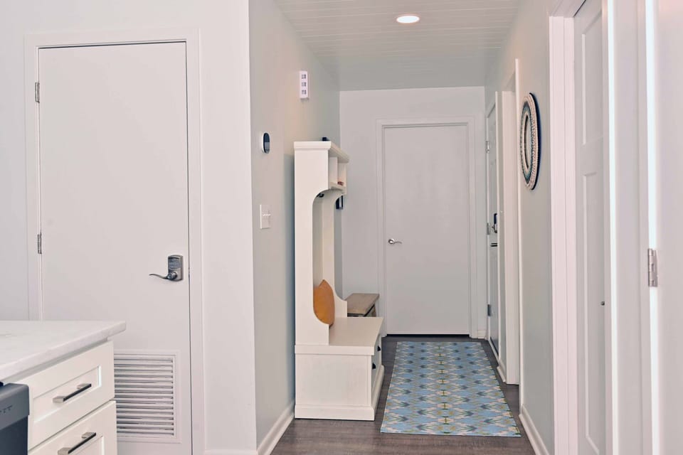 Welcoming entry foyer with bench seating and space to drop shoes and bags