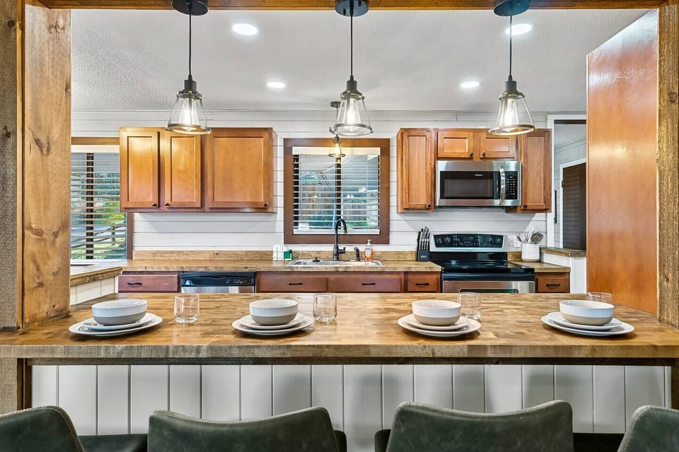 The brightly lit open kitchen and dining area is fully stocked for easy living