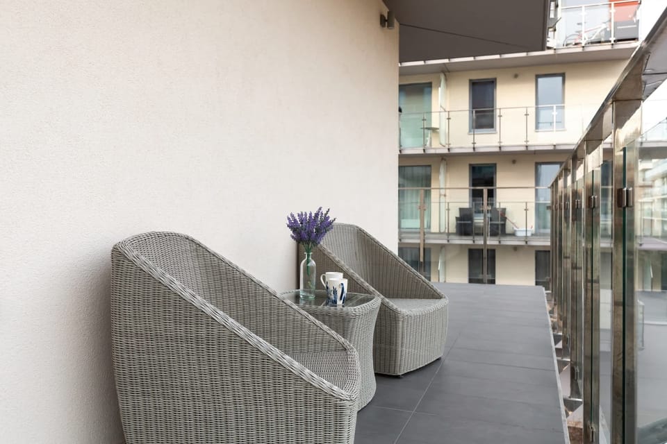 Balcony with outdoor seating and a peaceful view of the neighborhood.
