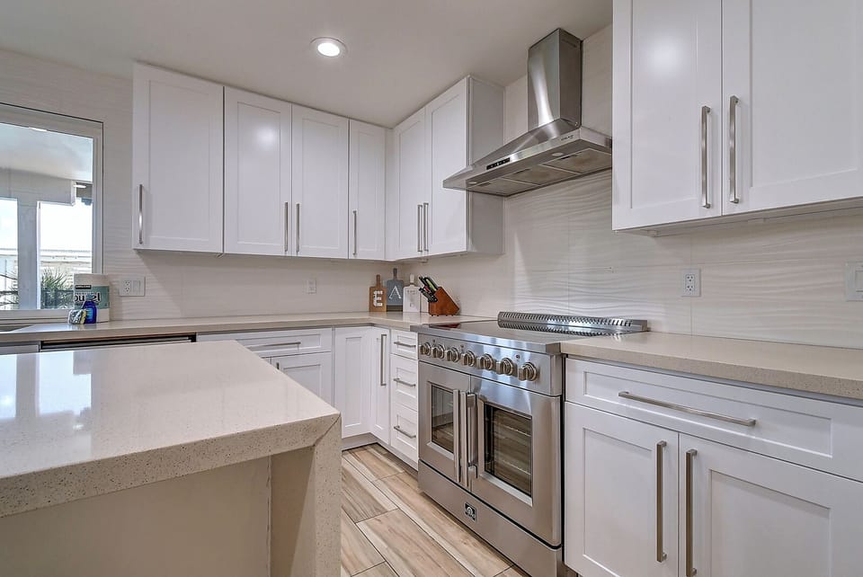 Modern kitchen with oversized industrial 6 burner French door oven.