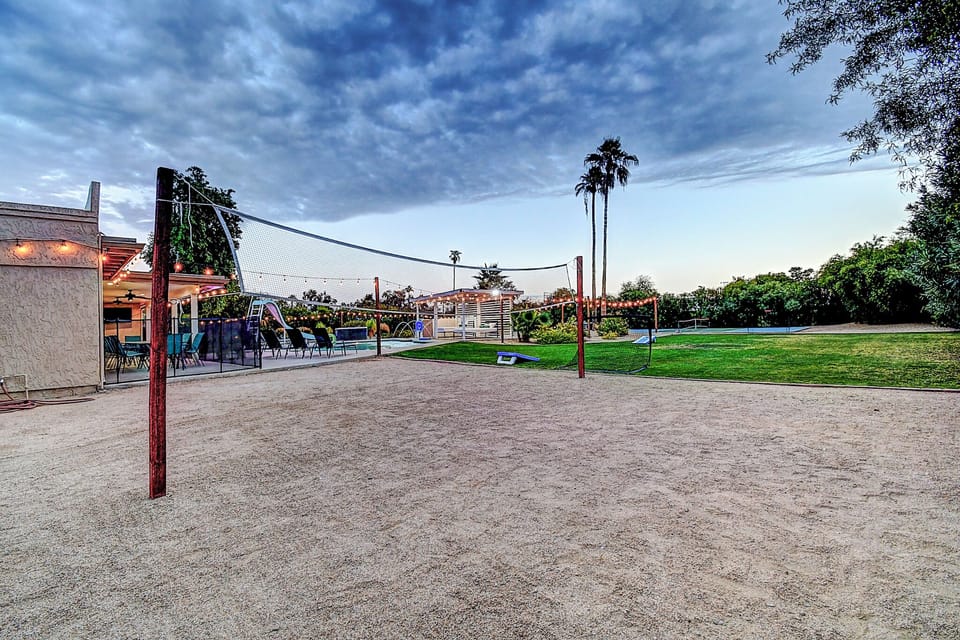 The acre estate's volleyball court and large grassed sports/yoga real grass area