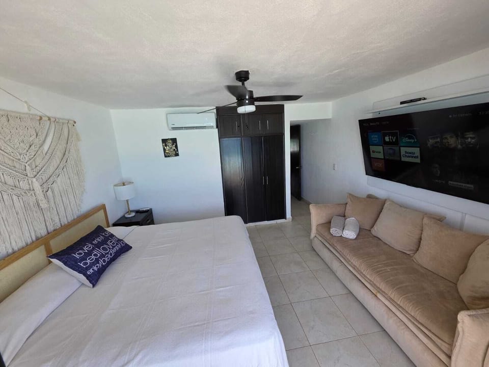 Principal bedroom with king size bed and tv
