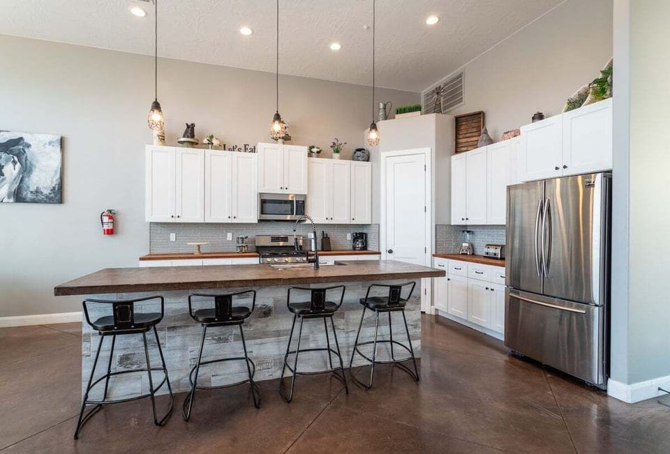 Experience the joy of cooking in this fully equipped kitchen. With an array of utensils, cookware, and modern appliances at your fingertips, you'll feel right at home preparing meals for family and friends.