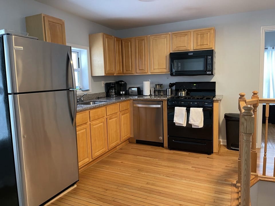 Full kitchen on 2nd floor with stove, oven, refrigerator, dishwasher. 