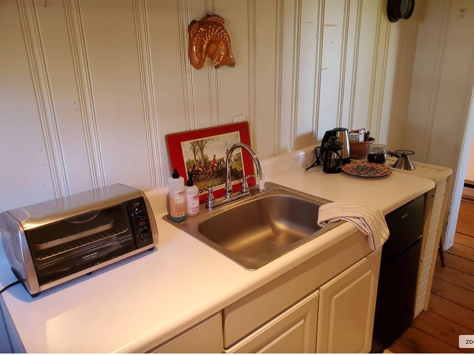 Kitchenette includes: sink, fridge, toaster over, electric kettle & basic dishes
