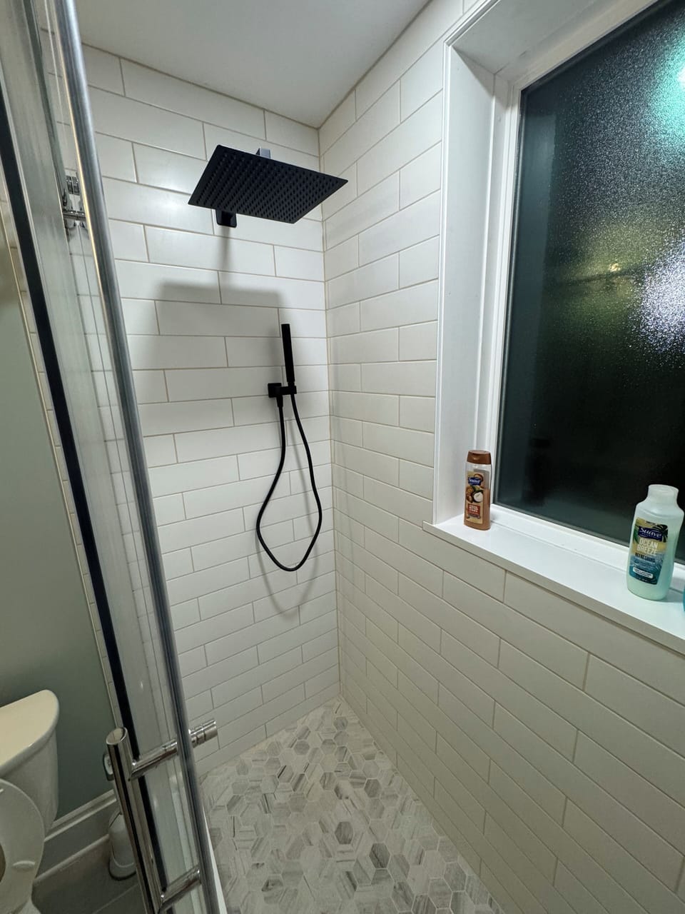 Relaxing in the updated shower with rain shower head.