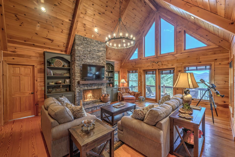 Main level living room with a view, game cabinet, telescope, wood fireplace 