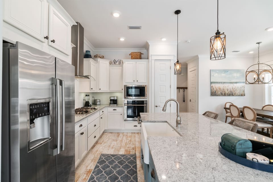 Another view of the well-stocked kitchen equipped with high-end appliances and a Keurig combo drip coffee maker.