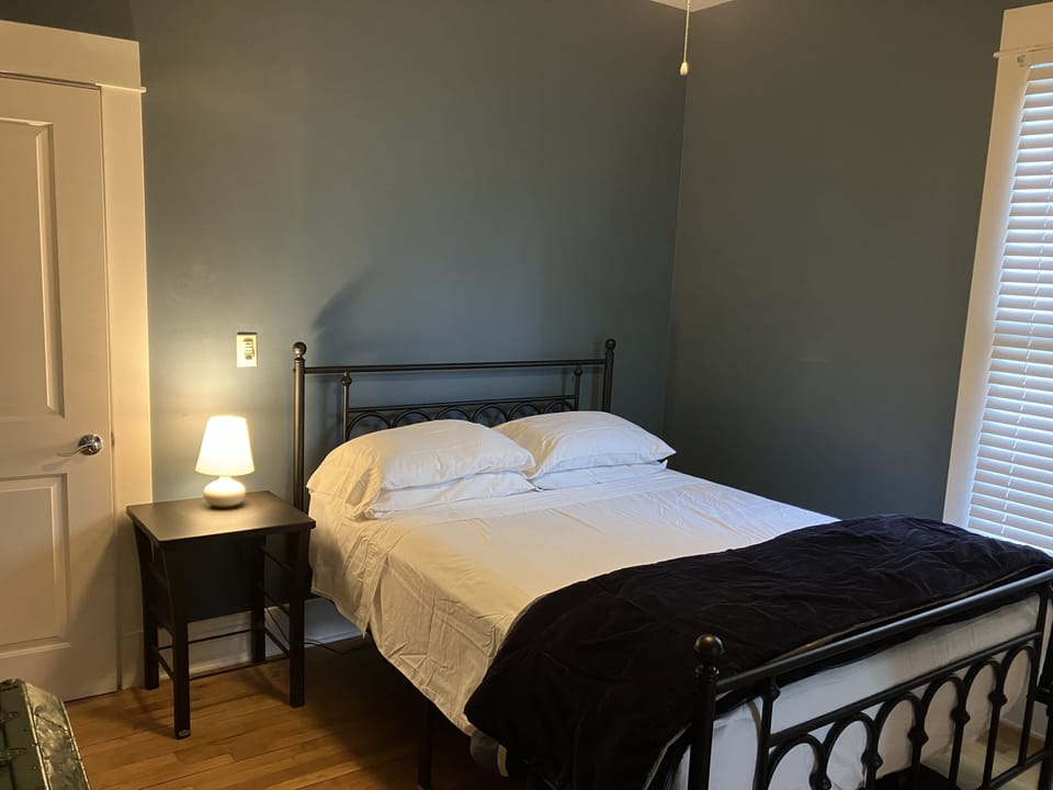 First floor middle bedroom: double doors out to the living room, door to back.