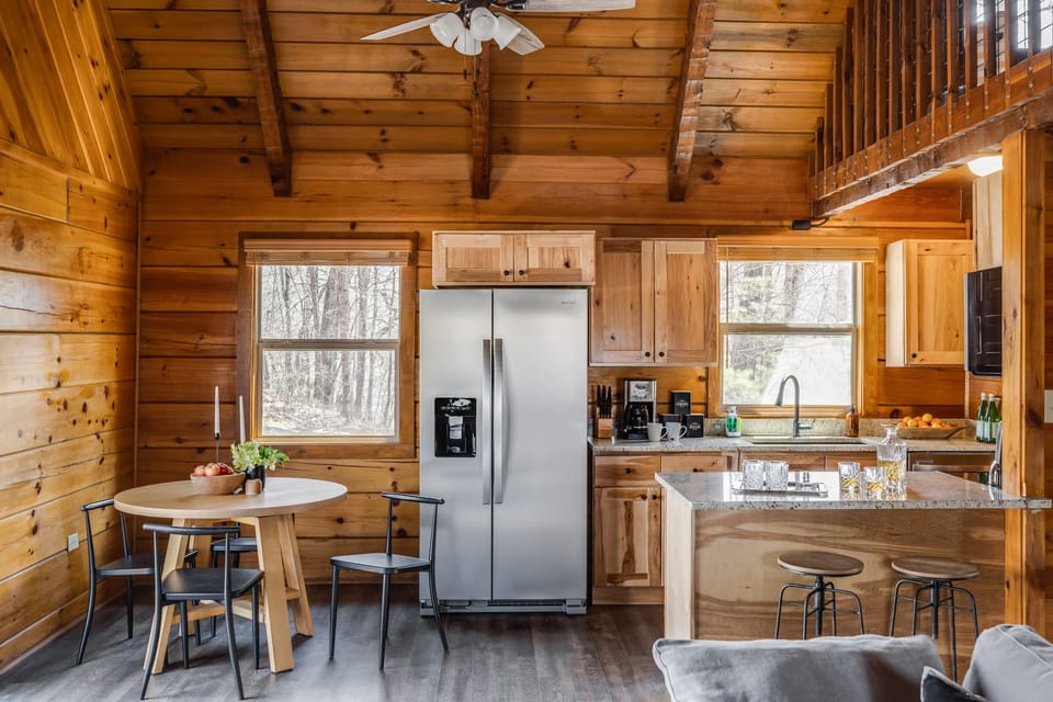 Kitchen features modern appliances and an island with counter-top seating.