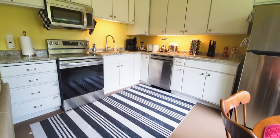 Fully equipped kitchen with new appliances, cookware, condiments, coffee and tea