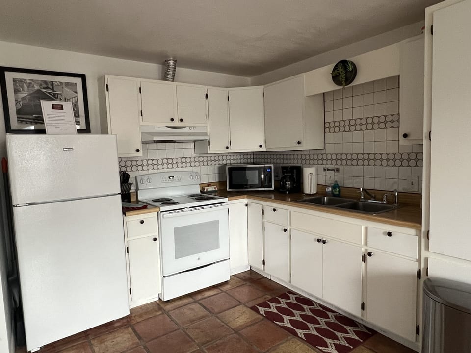 Full size kitchen with pots, pans, utensils, and cooking necessities.