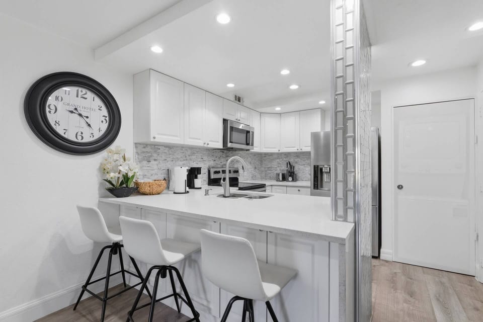Cook, dine, and connect in the fully updated kitchen featuring quartz countertops, stainless steel appliances, and bar seating.