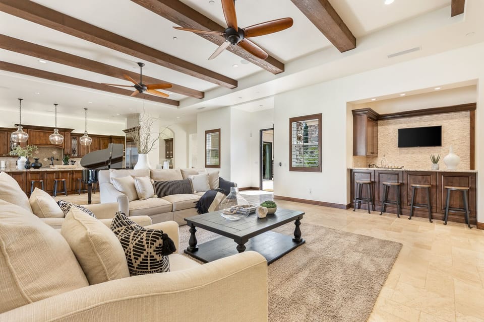 Great room perfect for entertaining with tons of seating and a great bar area with wine fridge and ice maker