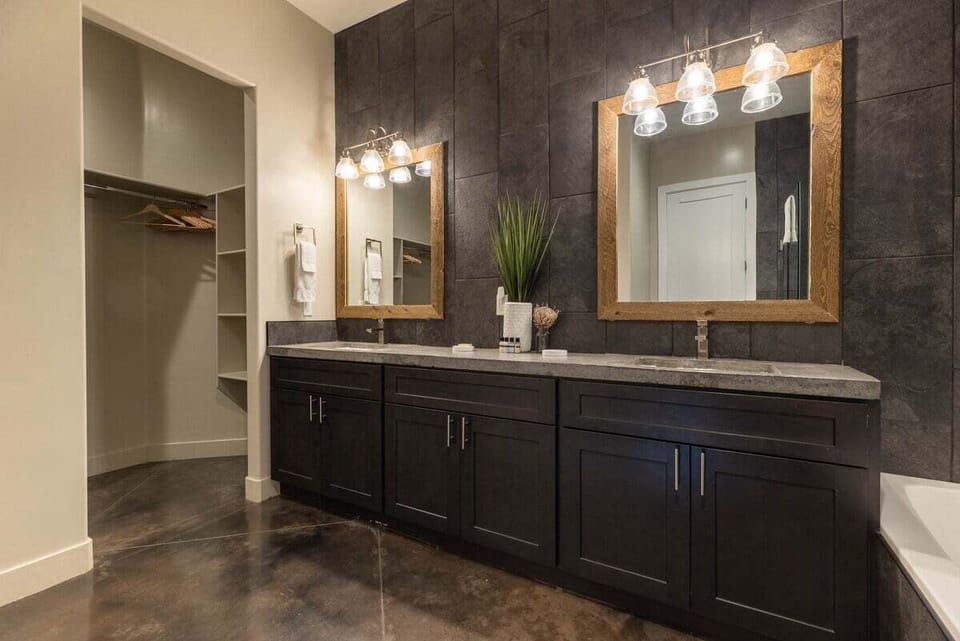 This master bathroom is designed for relaxation, showcasing a spacious walk-in shower and large soaking tub.