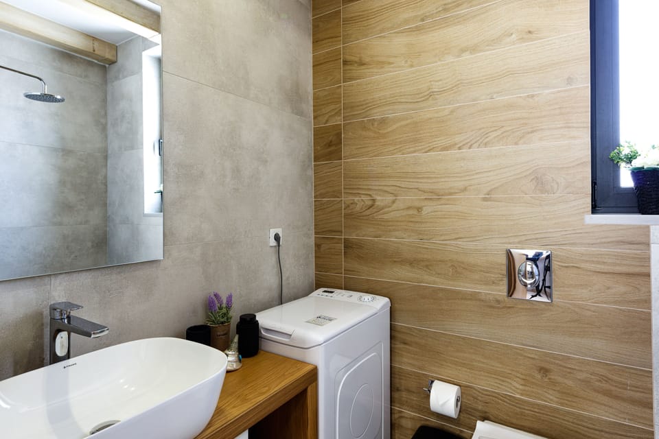 Ground floor bathroom with a washer for added convenience.