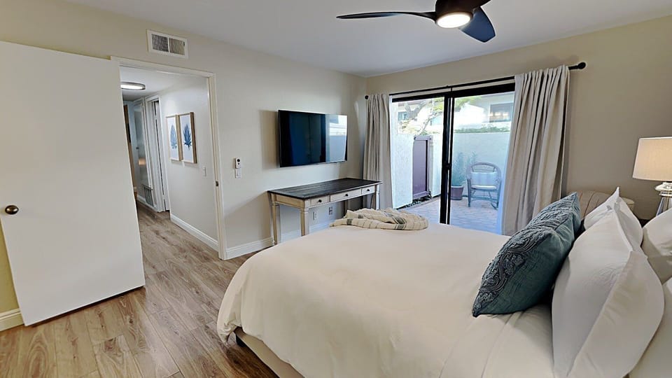 Master Bedroom with Queen Bed, TV, and Patio
