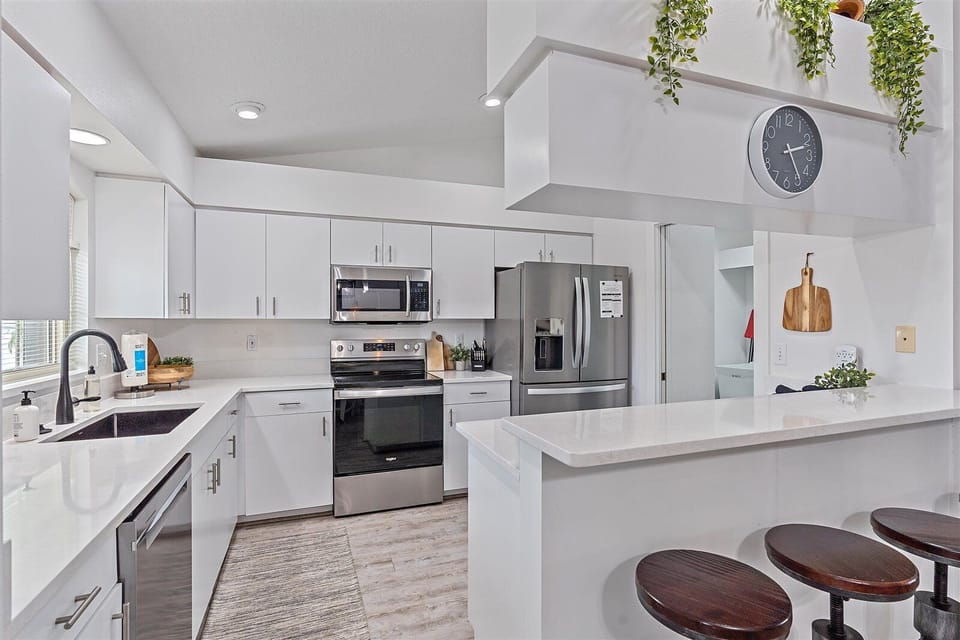 Fresh white kitchen cabinets w/ plenty of countertop space.