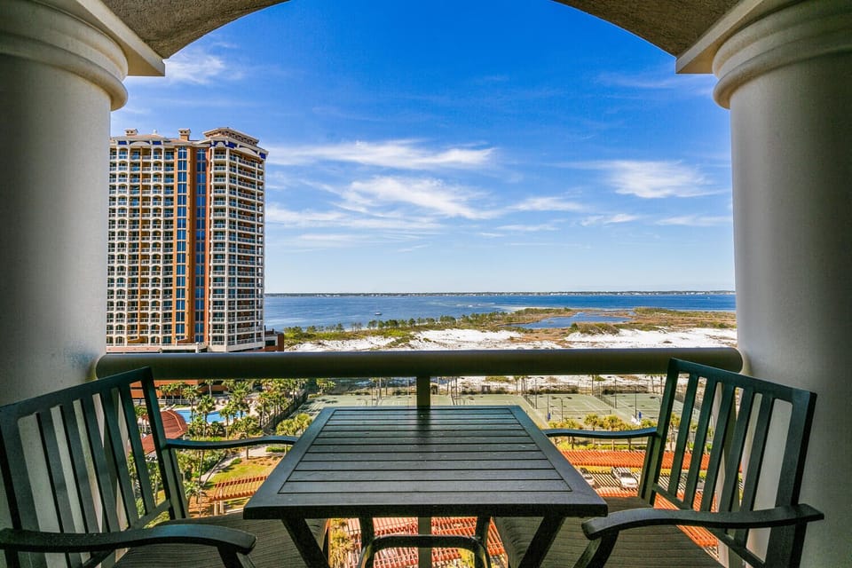 Enjoy your morning coffee at this peaceful balcony table, where sweeping bay views and coastal breezes set the perfect tone for a relaxing coastal escape.