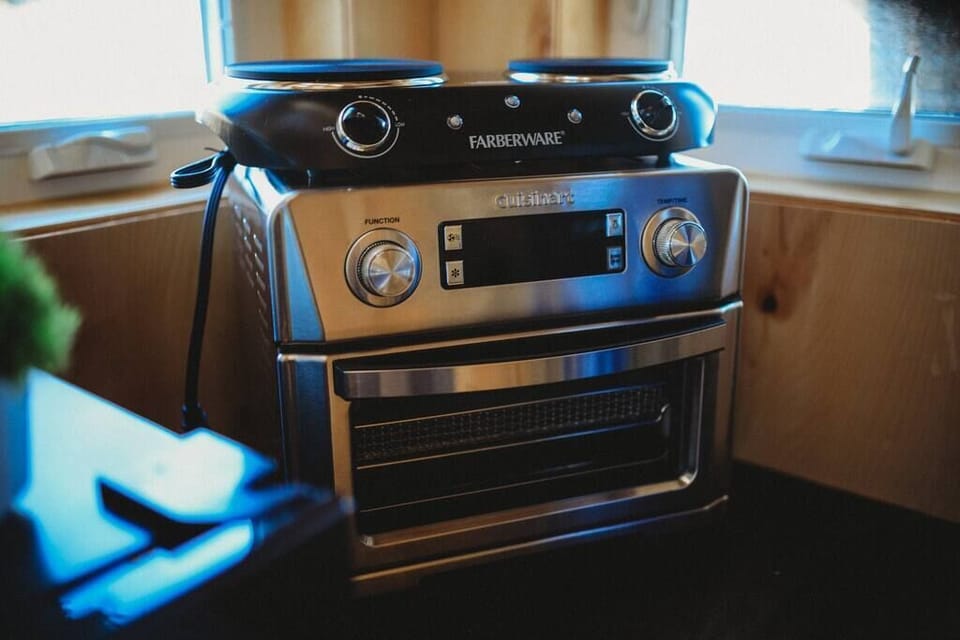 Cook with ease using high-quality appliances, including a sleek toaster oven, perfect for quick and delicious meals during your stay.