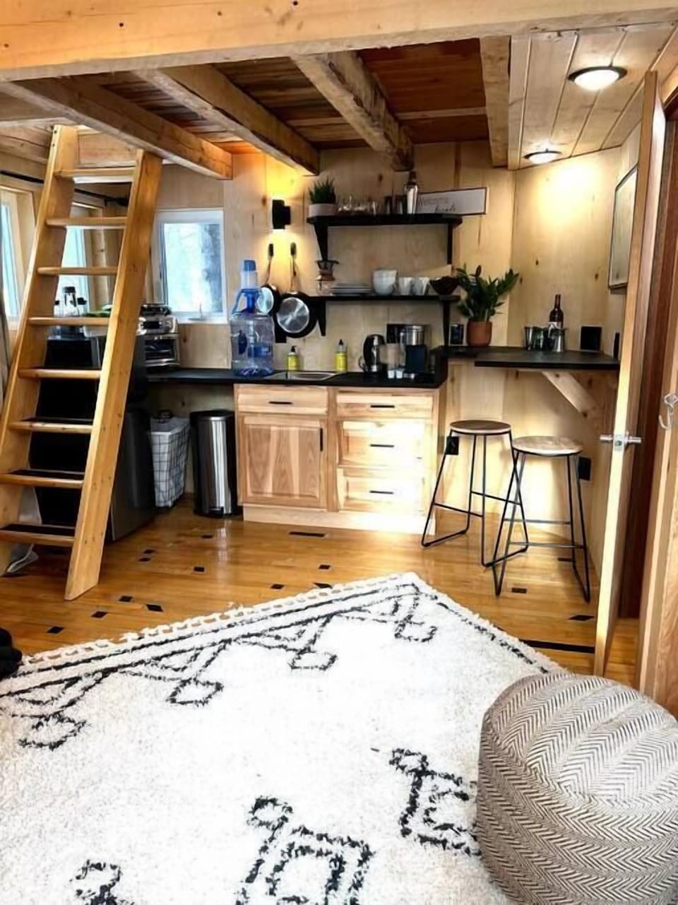 Enjoy a fully equipped kitchenette with rustic wood finishes, cozy seating, and modern amenities, creating a perfect balance of charm and convenience for your stay.