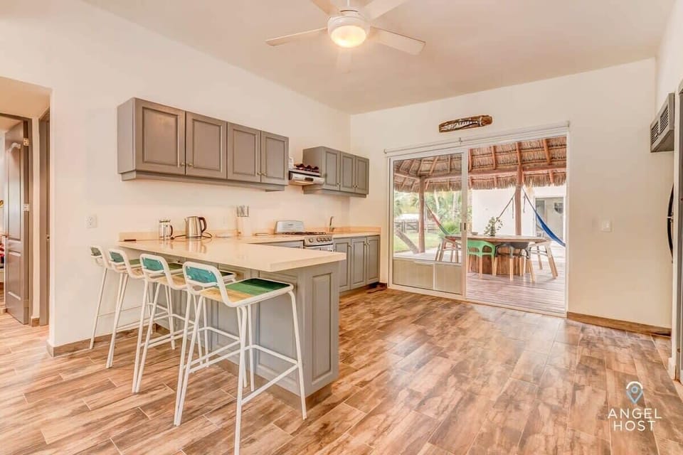Open kitchen with breakfast bar seating and easy outdoor access.