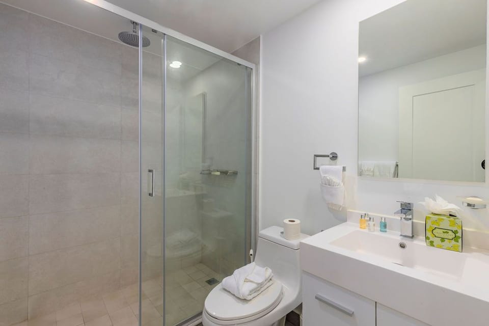 Refresh in your sleek, modern bathroom with a spacious walk-in shower, crisp white finishes, and fresh towels waiting for you after a day of adventure.