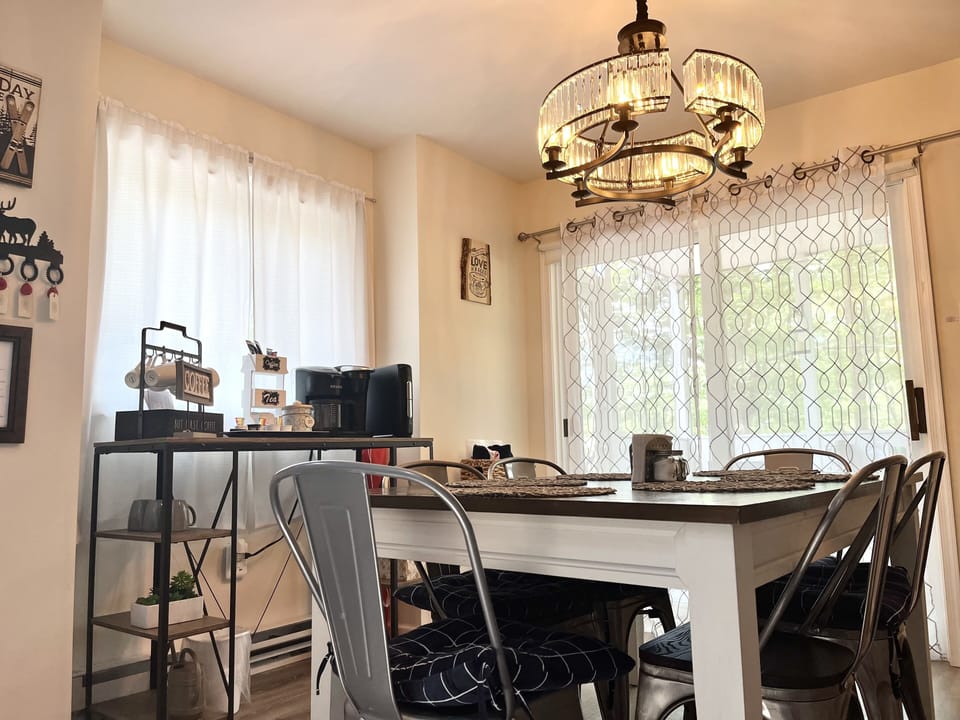 The dining room has views of the ski lift / slope & wooded mountains