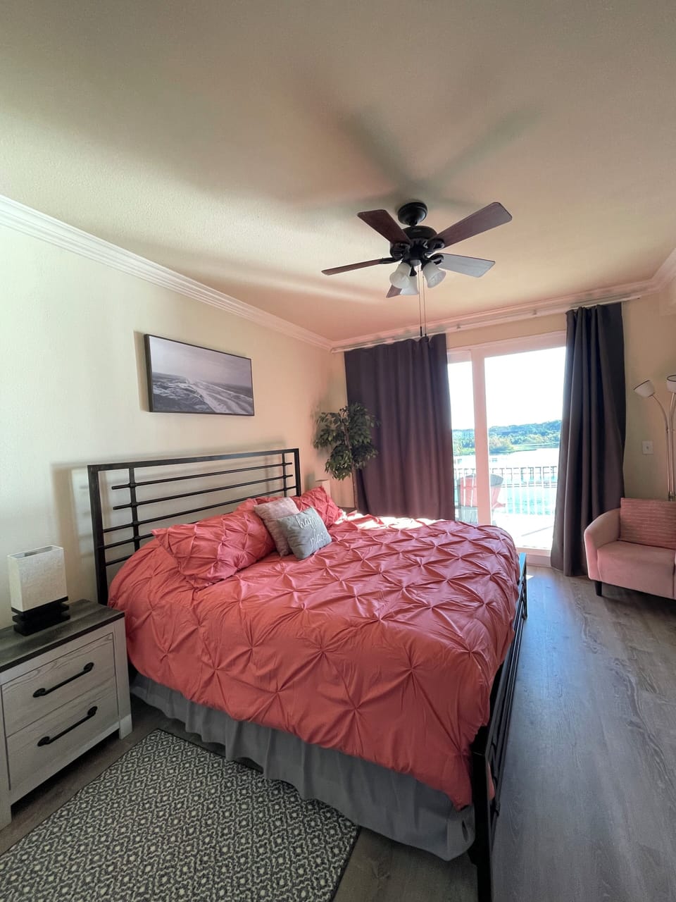 Master bedroom has a comfy reading chair and a reading light. 