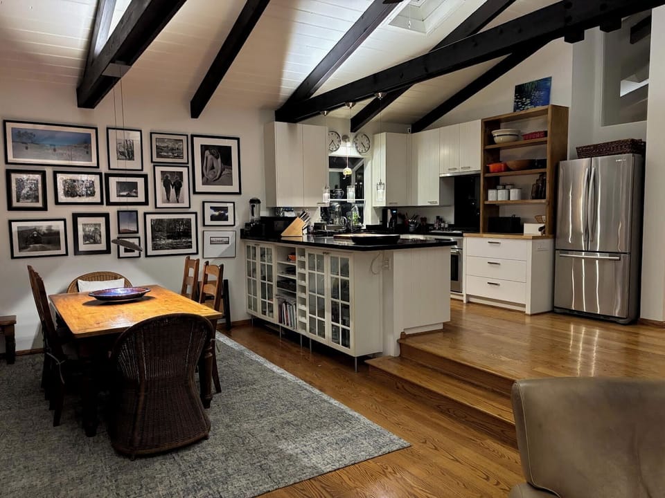 Large dining table and steps above - the newly expanded gourmet  kitchen