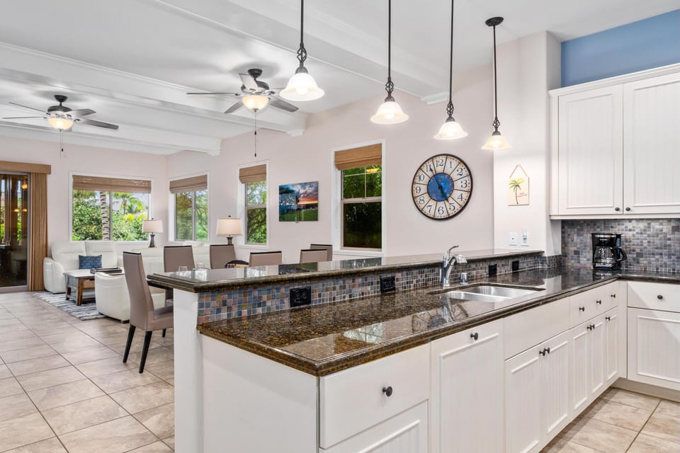 Full kitchen with breakfast bar and granite counters