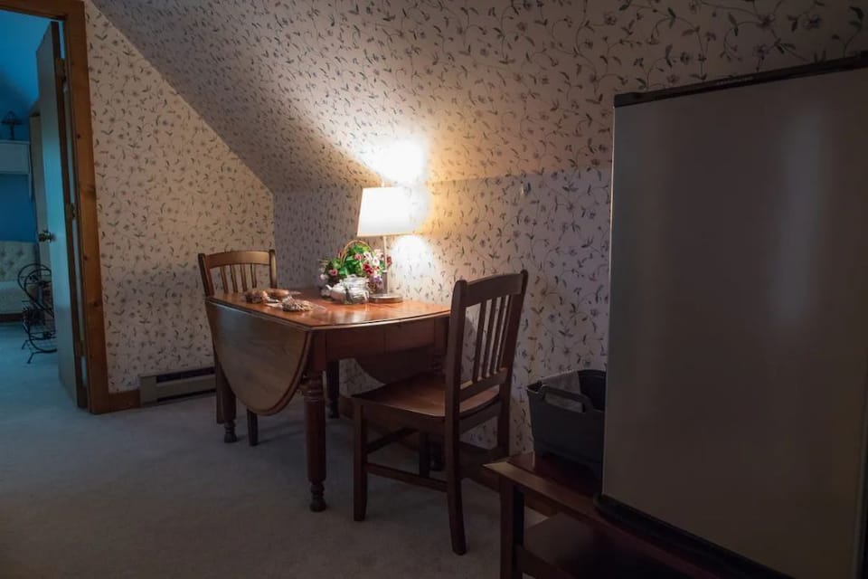 A small refrigerator and dishpan provided.
