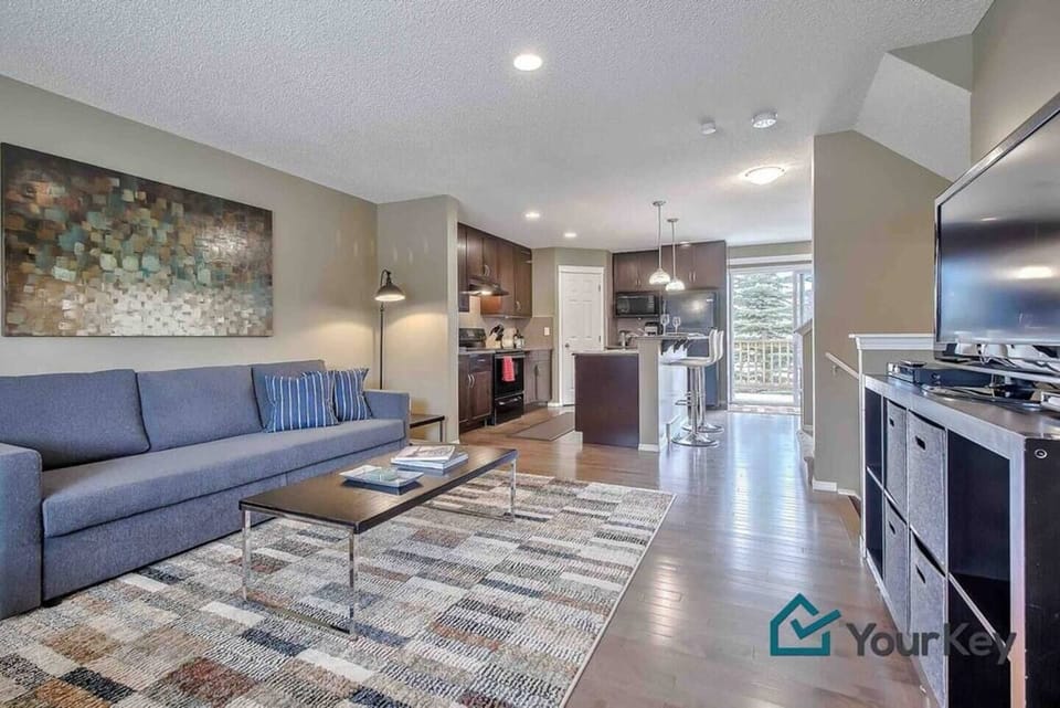 Welcome to your home away from home! This is the main living area with pull-out sofa, TV, and views of the front and back porch. 