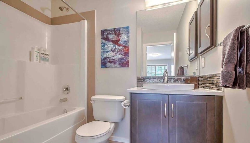 Plenty of fresh linens, hand soap, shampoo, conditioner, body wash, toilet paper, a blow dryer and space for you to store your belongings (toothbrush holder, counter space, etc.). 
One of the two full bathrooms has a tub (pictured). 