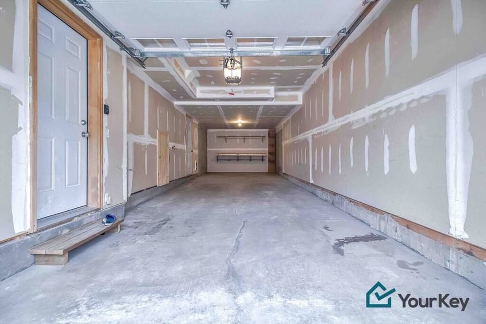 Tandem garage for two cars inside and still room for more outside. If you prefer to park outside it makes a good space to store belongings. 